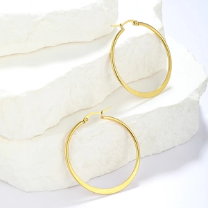 Minimalist large gold plated stainless steel hoop earrings on white stones