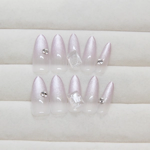 Long almond cat-eye press-on nails with purple gradient glitter and crystal rhinestones