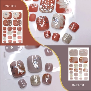 Detail of waterproof pedicure stickers with floral patterns and glitter finish