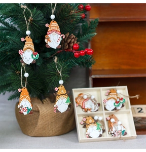 Detail of wooden Christmas gnome pendants set in a gift box and on a holiday tree