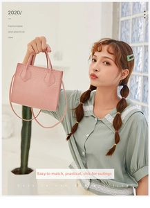 Detailed view of a pink crocodile texture handbag worn as a stylish crossbody bag