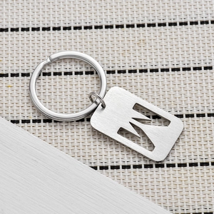 Macro shot of silver metal key ring with letter N cut-out and brushed texture finish