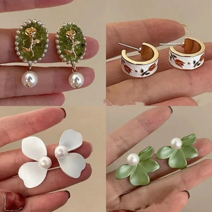 Four pairs of floral pearl earrings featuring rose and tulip designs in green and white