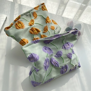 Detail of floral jacquard cotton makeup pouches with metal zipper and Scalkk label