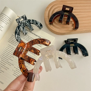 Acetate semicircular hair claws in navy, tortoiseshell, marble and pearly white finishes