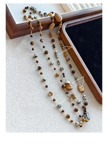 Detail of 14K gold plated necklace with dalmatian jasper and tiger eye beads