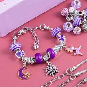 Detail of purple bead bracelet set with moon and snowflake charms for DIY jewelry making