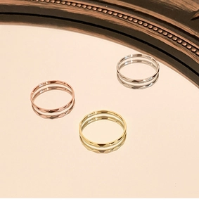 Detailed shot of faceted titanium steel rings in silver, gold, and rose gold finishes