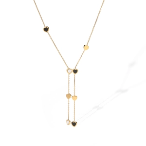 Close-up of gold-plated stainless steel chain with layered black and white heart charms