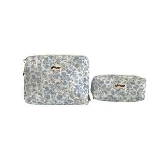 Quilted floral makeup bag set in blue flower print with zipper and handle for storage