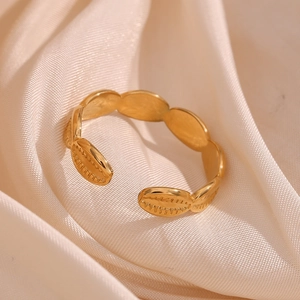 Detailed macro view of an adjustable 18K gold-plated ring with seashell texture