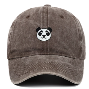 Close-up of black and white panda embroidery on a vintage washed brown cotton baseball cap