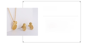 Macro shot of 18k gold plated stainless steel pineapple pendant and earrings set