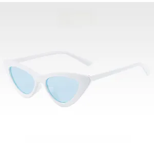 Detail view of white retro cat eye sunglasses with light blue translucent lenses