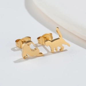 Detailed macro view of golden stainless steel cat silhouette stud earrings for women