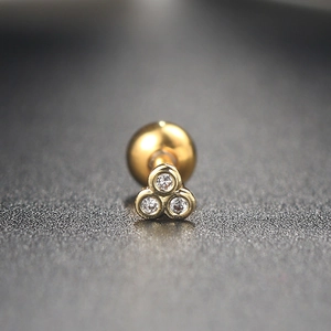 Macro shot of triangle zircon stud earring with gold base and screw ball back closure