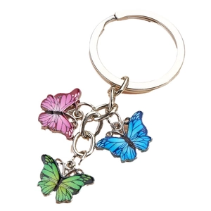 Colorful metal butterfly keychain featuring pink, blue, and green charms on silver rings