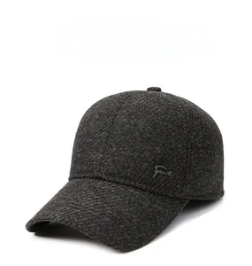 Close-up of a men's winter thermal baseball cap with metal logo detail and warm grey fabric