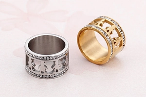 Close-up of brushed titanium steel rings with hollow couple figures and inlaid zircons