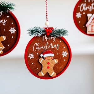 Felt gingerbread man Christmas tree ornament with Merry Christmas print in red and brown