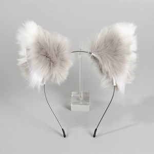 Detailed view of fluffy black and white faux fur cat ears on a thin metal headband