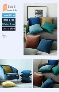 Detailed texture of soft velvet pillow covers in various blue shades on a modern sofa