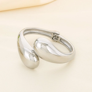 Minimalist irregular cross open bangle in polished silver stainless steel finish