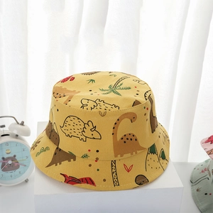 Yellow kids fisherman hat with cartoon dinosaur prints on white background
