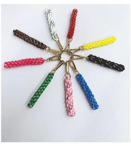 Radial arrangement of colorful handmade woven keychains with golden metallic clasps