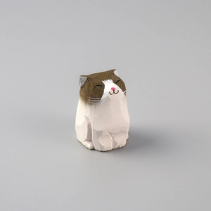 Detailed view of a hand-carved wooden cat figurine with brown and white painted textures