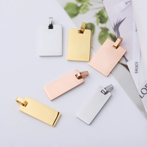 Flat lay of rectangle stainless steel pendants in silver, gold, and rose gold finishes