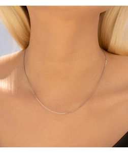 Close-up of minimalist S925 sterling silver chain necklace worn on a female neck