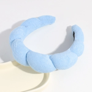 Cloud padded headband in light blue plush fabric, perfect for daily face washing and chic styling.