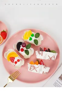 Realistic fruit cupcake models with strawberry and blueberry toppings on a pink plate