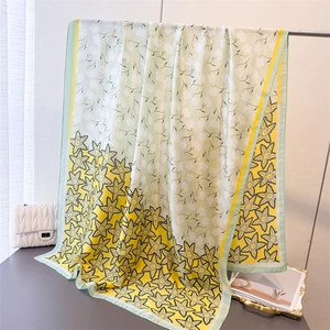 Floral silk-like scarf featuring elegant yellow and mint green prints with star patterns