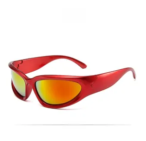 Detail view of red wrap-around Y2K sunglasses with orange gradient lenses in steampunk style