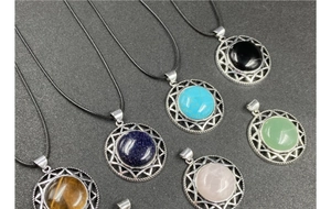 Collection of hexagram crystal pendants in various gemstones on black cords