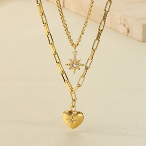 Close-up of gold-plated double-layer necklace with heart and star zircon pendants