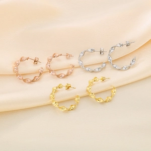 Minimalist twisted hoop earrings set in rose gold, silver and gold finish on satin