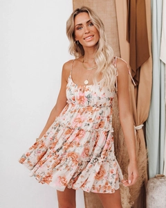 Detailed view of the layered floral sundress with thin straps and ruffled cake hem