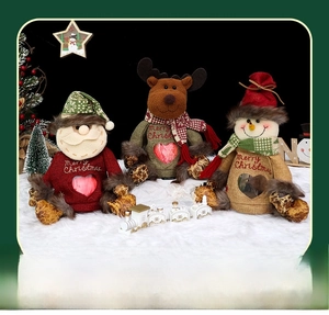Detailed view of Christmas burlap gift bags featuring Santa, elk, and snowman motifs