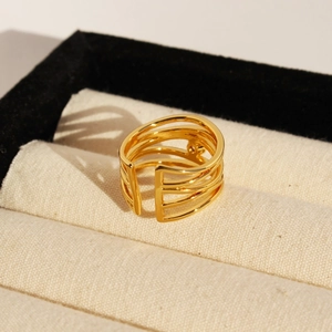 French vintage gold open ring with irregular layered lines and zircon details on display