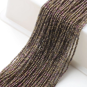 Macro shot of 2mm bronze-gold faceted glass beads for jewelry making and DIY chains