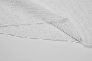 Detailed close-up of white breathable ice silk knitted fabric with neat hemmed edges