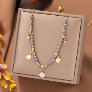 Detailed macro shot of a beaded titanium steel necklace on a khaki jewelry display box