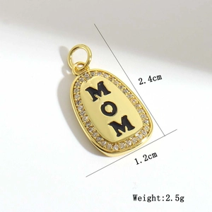 Macro detail of gold-plated MOM oval pendant with cubic zirconia and dimension labels