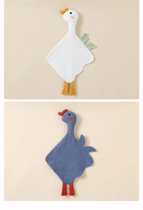 Detailed close-up of soft cotton muslin baby comforters in goose and rooster shapes