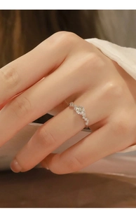 Close-up of sparkling moissanite ring with micro-pave diamonds on model's hand