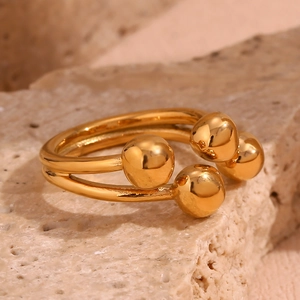 Detailed close-up of 18K gold-plated double-band open ring on a textured stone base
