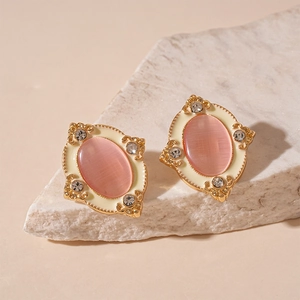 Vintage gold oval earrings with pink cat-eye stone and crystal accents on stone base